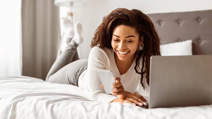 Portrait Of Cute Black Girl Looking At Her Cell Phone, Reading Love Message From Boyfriend, Lying In Bed 60031436 Stock Photo at Vecteezy