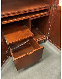 Perfect for laptops or to hide away papers or a desktop keyboard, this delicately scaled desk offers abundant organization assistance in just a tiny space. Dark Wood Hideaway Desk Heirloom Home