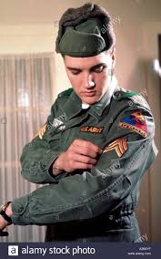 ELVIS PRESLEY admires his sergeant's strips in January 1960 Stock ...