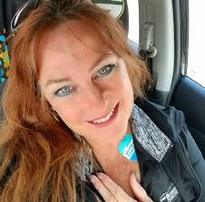 What is the name of the plant that has been growing for 11 years and is now  blooming with purple flowers?