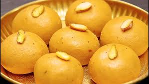 Besan Laddus, round yellow sweet balls made from gram flour and ghee, on a traditional plate