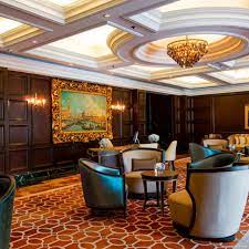 The hotel lobby features marble floors and paneled walls. Hotel The Ritz Carlton Kuala Lumpur Malaysia Bei Hrs Gunstig Buchen