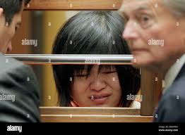 Dr Hsiu Ying "Lisa" Tseng cries during her arraignment, flanked by  attornies, Edward Welbourn, left, and Alan Stokke, Friday, March 16, 2012  in Los Angeles. Tseng, a California doctor, has pleaded not