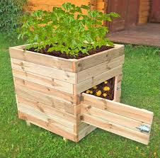 Most potato towers are made from chicken wire, wood, stacked buckets, or even rubber tires. This Wooden Potato Planter Has A Door To Easily Access Your Home Grown Potatoes