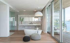 Luxurious modern white bathroom with dark wood floors. White Wood The Best Combination For Perfect Bathroom