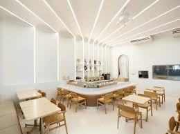 A rich blue tone emanates from behind opaque glass in the kitchen island, giving the bar space a beautiful glow. Restaurant Bar Design Awards Shortlist 2019 Visi
