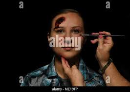 Regina Parker, 81st Medical Operations Squadron mental health clinic  secretary, applies moulage