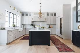 Modern Farmhouse Kitchen This Modern Farmhouse Kitchen Features Plenty Of Cabinetry And Large Island Black Kitchen Island New Kitchen Cabinets Kitchen Cabinets