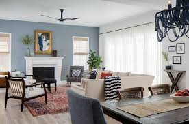 Navy blue and gold dining chairs surround a brown wood dining table placed beneath a chandelier finished with purple shades. Classic Home With Blue And White Interiors Home Bunch Interior Design Ideas