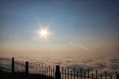 The iconic sunrise view above the low-hanging morning mist at Nandi Hills..