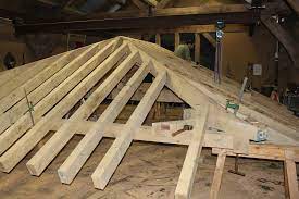 Hip roofs or so called hipped roofs are a special type of roof that has a very gentle slope at the sides with a downward pattern towards the side walls. Jowl Post Our Oak Frame Blog Building A Roof Under A Roof Oak Frame Houses Buildings And Extensions Bespoke Hand Crafted Oak Frames For Your Complete House Timber Frame Extension Porch Or