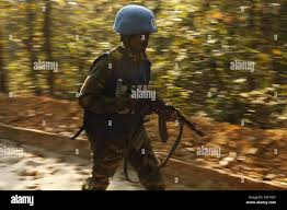 A U.N. Peacekeeper from the Bangladesh Army advances during a simulated  firefight as part of a field training exercise during Exercise Shanti Doot  4 in Bangladesh. Shanti Doot 4 is a multinational