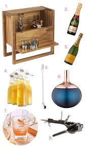 A small and cool home bar made of an ikea piece, with a bright artwork, copper barware and gold edge glasses. Small Space Home Bar
