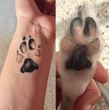 Dog paw tattoo behind ear. 23 Surprisingly Sweet Stunning Paw Print Tattoos