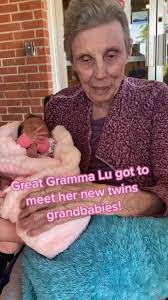 Elderly woman with dementia lovingly rocks a baby