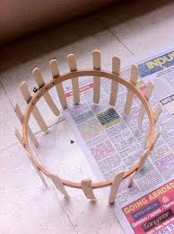 The humble popsicle stick can be transformed into incredibly cool crafts to do with your kids, and all you need is imagination and a few arty bits and pieces to join in the fun. Knitting Loom Made From An Embroidery Ring And Ice Cream Sticks 10 Minutes Loom Craft Diy Knitting Loom Diy Crafts