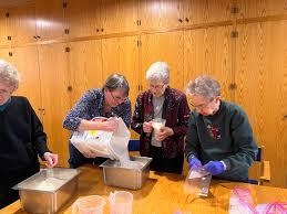 Sisters Lucy Miller, Dorothy Manuel, Judy Huber, Katherine Kraft, Katherine  Howard, Pat Ruether, Lucinda Mareck, and Laura Suhr joined Elizabeth Reum,  director of social justice ministries, to pack beans and rice, which