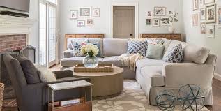 It masters the blend of chic with functionality. Light Gray Skirted Sectional With Round Wood Coffee Table Cottage Living Room
