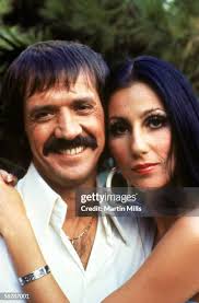 Cher, the ex-wife of Sonny Bono, places a white rose
