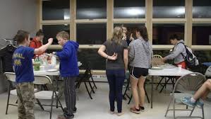 Local swimming coach hosts pot luck for folks without power