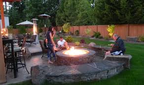 If you're looking to add a warm and welcoming focal point to your back yard, you may want to explore the pros and cons of propane vs. How To Elevate Your Backyard With An Outdoor Fire Pit