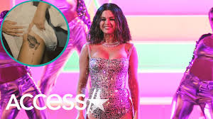 Word 'rare' tattoo on neck. Selena Gomez Gets Tattoo On Her Upper Thigh See The New Ink Youtube
