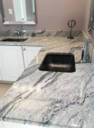 Black And White Granite Countertops With White Cabinets Gorgeous Viscont White Granite Vanity Countertop That Is Paired With White Cabinetry And Bla Granite Countertops Kitchen Marble Granite Countertops Countertops
