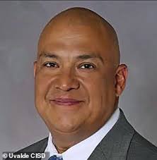 Identity of Uvalde officer dubbed 'hand sanitizer cop' is REVEALED