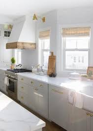 Antique Brass Hardware On Light Gray Shaker Cabinets And Drawers Transitional Kitchen In 2020 Grey Shaker Kitchen Brick Kitchen White Quartz Countertop