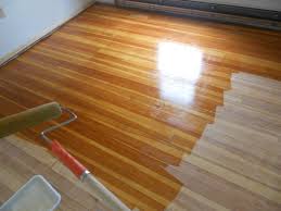 Using A High Density Roller To Apply Polyruethane Sealant Varnish Flooring Wood Floors Refinish Wood Floors