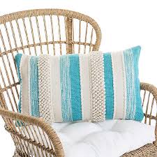 The deep teal on this oversized dark teal tassel indoor outdoor lumbar pillow ($20) looks stunning on light furniture pieces. Turquoise Striped Woven Outdoor Pillow Kirklands