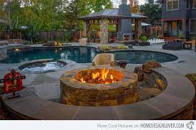 For example, imagine a brick fire pit surrounded with chairs filled with warm snuggly cushions. Fire Water Combo In 15 Traditional Pools With Fire Pits Home Design Lover Backyard Fire Backyard Pool Fire Pit Backyard
