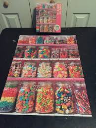 A ribbon cut puzzle has pieces which are all similar square shapes that line up in neat columns and rows creating a grid pattern. Candy Shelf Cobble Hill 500 Piece Jigsawpuzzles