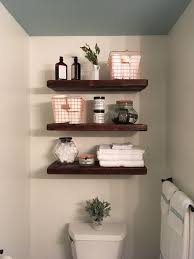 Use the space above the toilet to store extra toilet paper, folded towels, or decorations by adding some floating shelves. Diy Bathroom Shelves Above Toilet Trendecors