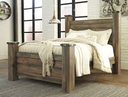 The Trinell Brown Queen Poster Bed Sold At Bailey S Furniture Serving Dallas Tx And Surrounding Areas In 2020 King Poster Bed Rustic Bedroom Furniture Poster Bed