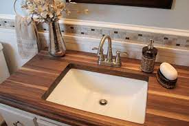 There are some disadvantages to using wood bathroom countertops, however. Small Bathroom With Walnut Wood Countertop Www Engraintops Com Bathroom Countertops Diy Wood Countertop Bathroom Wooden Countertops
