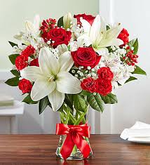 Vivid roses, asiatic lilies and carnations are placed in an elegant glass cylinder vase. Fields Of Europe Bliss Gidas Flowers Serving Pittsburgh Pa