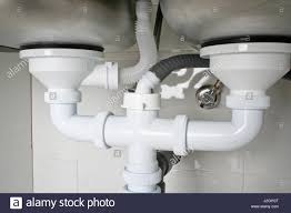 drain pipes under a kitchen sink with