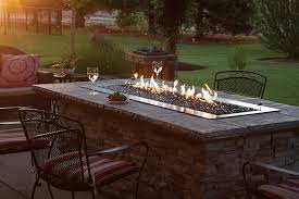 This wide gas fire pit features a classic stone look to add warmth and a calming atmosphere to your porch, deck, or yard. White Mountain Hearth By Empire Outdoor Linear Gas Fire Pit 60