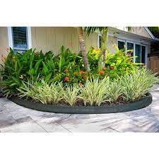 For a natural and affordable border, use a landscaping edger to dig a narrow trench around the outside of the bed, just inside your grass line. Ecoborder 4 Ft Black Rubber Curb Landscape Edging 4 Pack Curb Blk 4pk The Home Depot Landscape Edging Raised Garden Beds Diy Garden Edging
