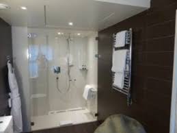 The customer uses a wheelchair and wants a curbless shower in a bathroom with a tiled floor. Paris Wheelchair Accessible Hotel Rooms Near Louvre Museum