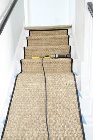 The essence of this design is the contrast between natural texture and a linear design. Painted Staircase Makeover With Seagrass Stair Runner