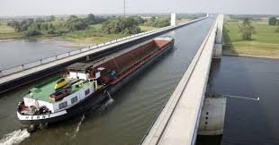 What country has a water bridge that allows massive ships to cross over another river? A Barge On The Magdeburg Water Bridge