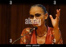Marina Silva, presidential candidate of the Brazilian Socialist Party, PSB,  left, and her husband Fabio Vaz Lima flash victory signs after voting in  general elections in Rio Branco, northern state of Acre,