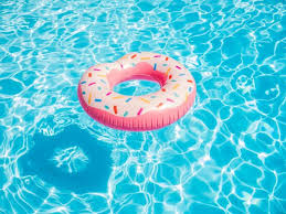 Pink Inflatable Donut Swimming Ring In A Swimming Pool Stock Photo Donut Inflatable Pool Swimming Pools