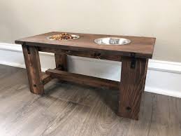 Pallet dog bed build a comfy dog bed on wheels that is made out of a wooden pallet then with the use of stensil, paint your pets name on the side. Diy Dog Bowl Stand For Your Puppies Shanty 2 Chic