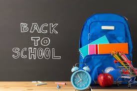 education or back to school concept backpack and stationery supplies on classroom desk with chalkboard background classroom desk chalkboard background back to school