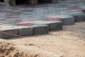Laying pavers over this material may pose problems to the drainage as concrete slabs have the inability to drain water through the blocks and into the earth. What Makes Brick Clay Pavers Better Than Concrete Pavers