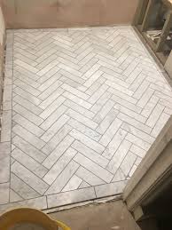 Calacatta gold (italian calcutta) marble. Carrera Marble Herringbone With Manhattan Grey Grout Kerryvilla Tottenham Reno Herringbone Tile Floors Marble Herringbone Tile Carrera Marble Bathroom Floor