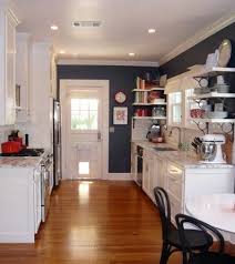 The Contrast Of Denim Blue And White Mixed With The Warm Wood Floors Inviting Navy Kitchen Walls Blue Kitchen Walls Kitchen Design